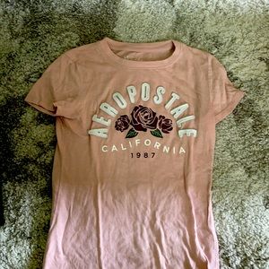 This is a light pink shirt with roses on it